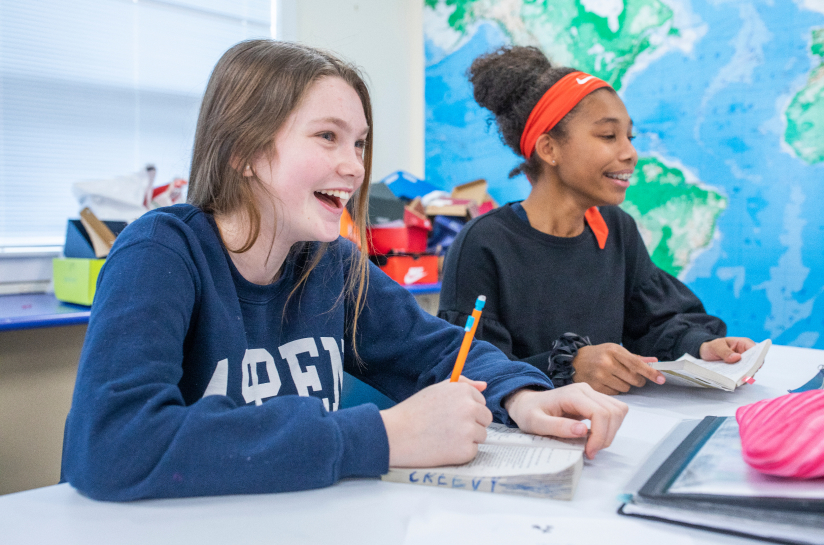 Students laughing and smiling during class.