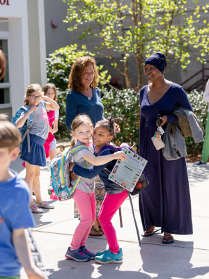 Students hugging outside of school