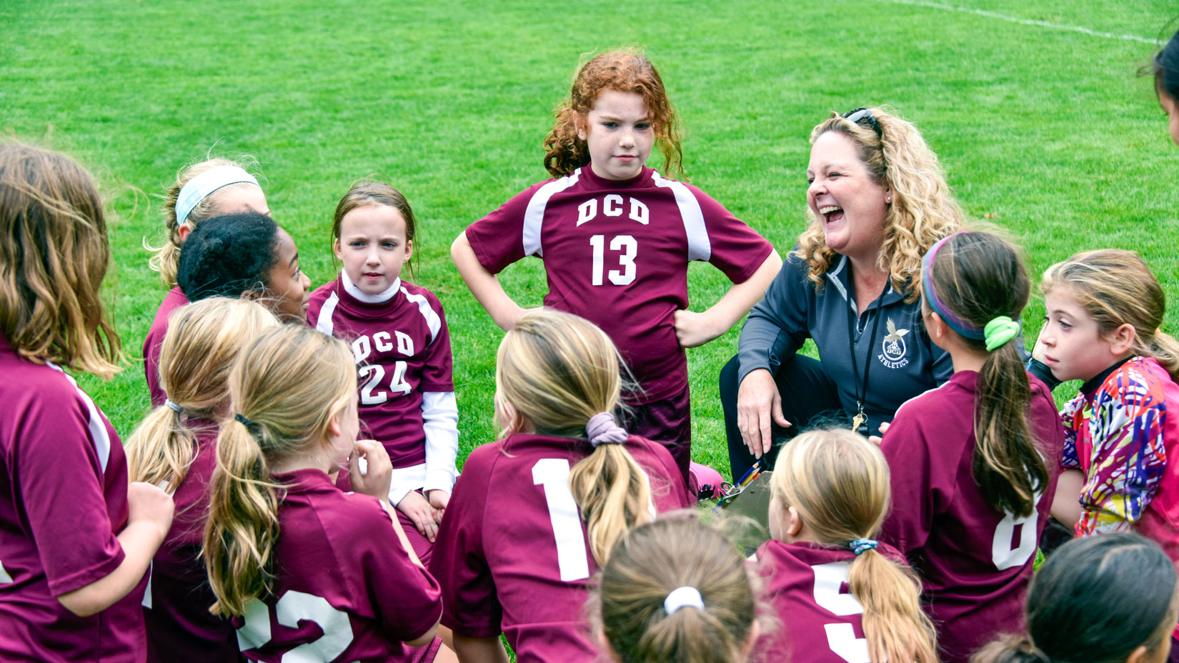 Students gathering to play soccer.