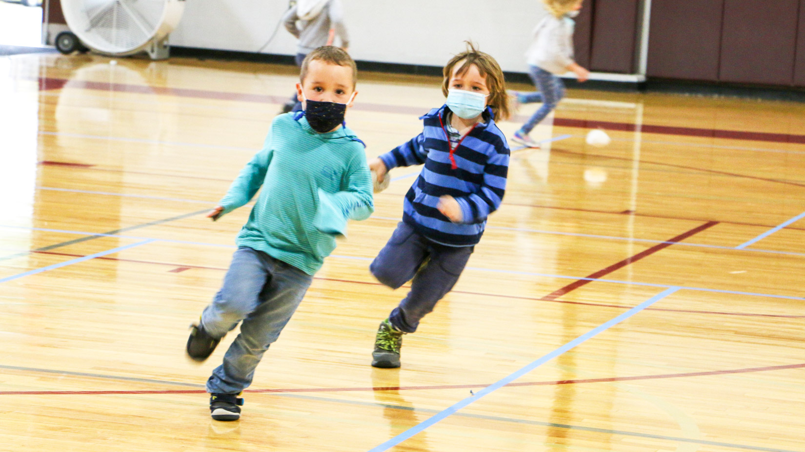 Students running in the gym.