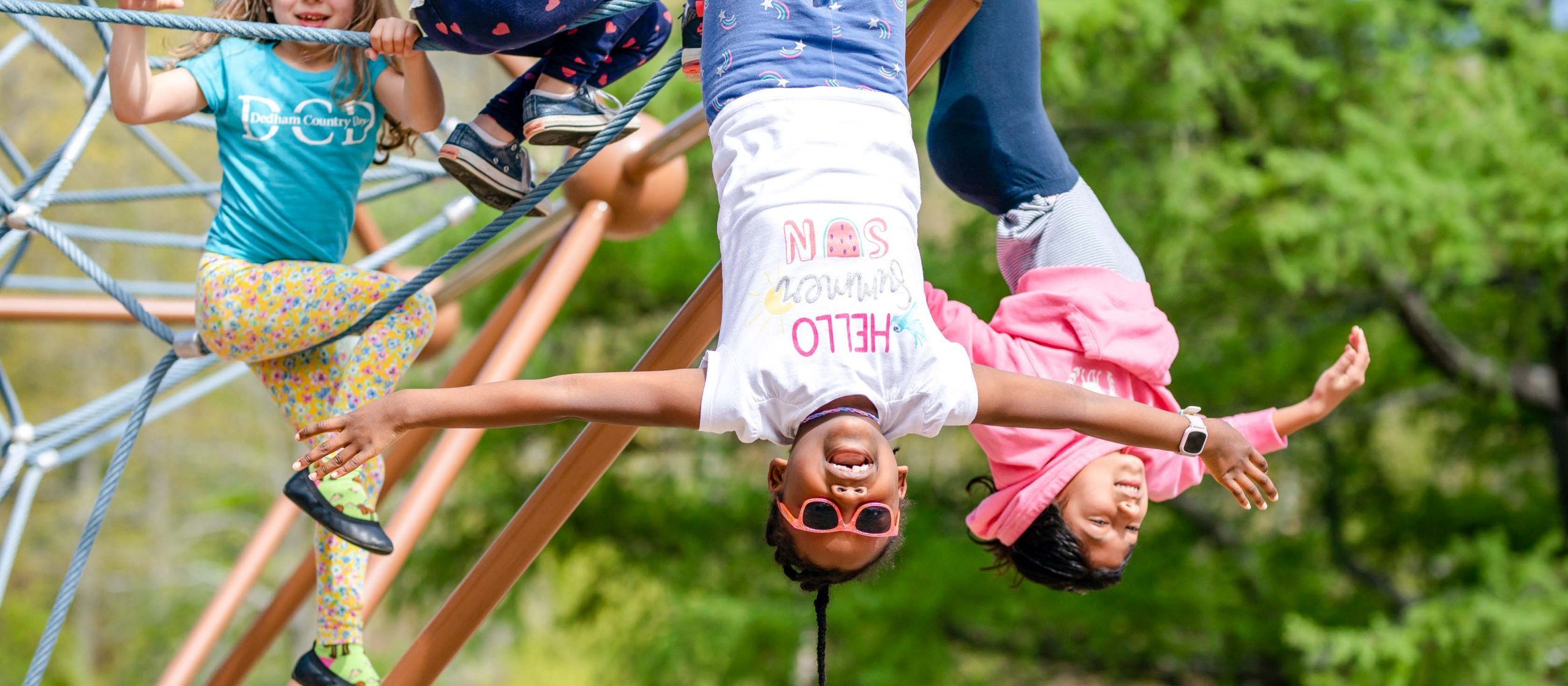 Students playing on the climbing ropes on the playground.