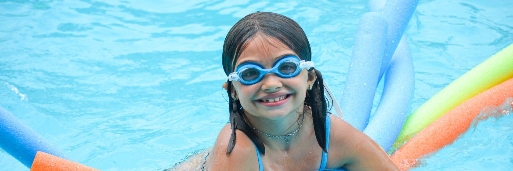 A camper floating and enjoying time in the pool.