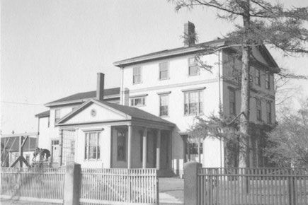 An exterior view of an old school building.