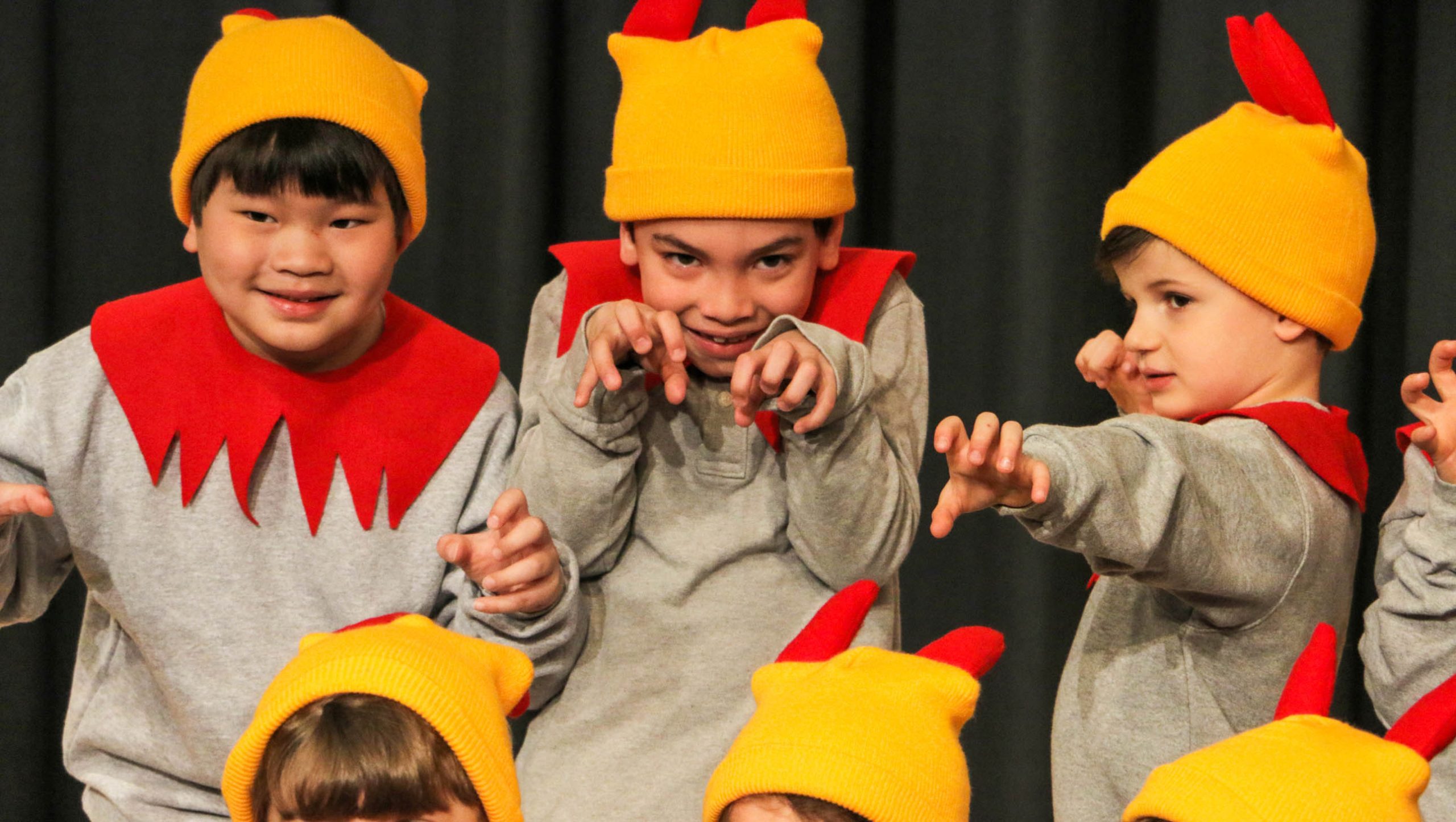 Students dressed up for a performance and posing on stage.