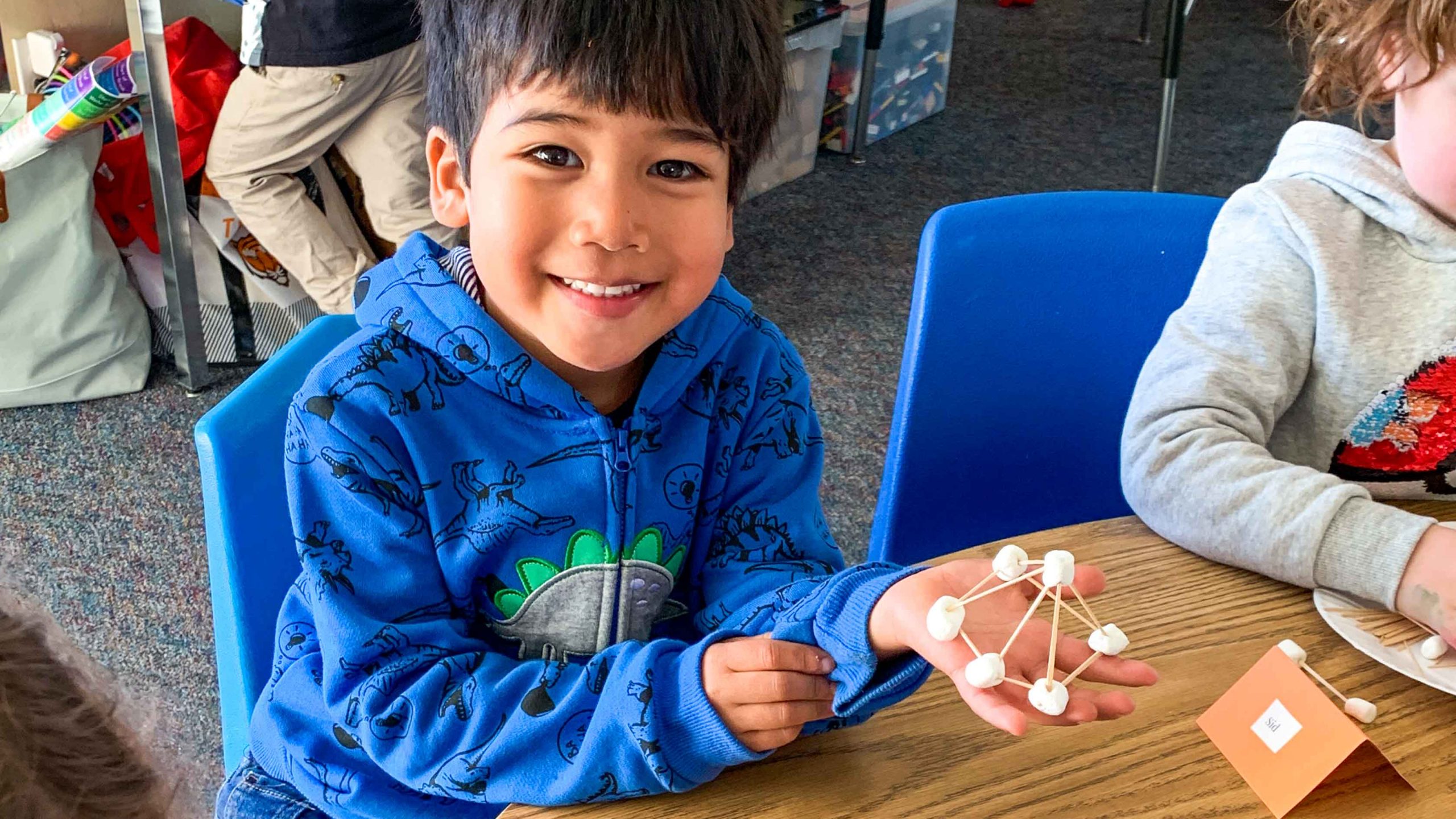 A student working on a crafting project in the extended day program.