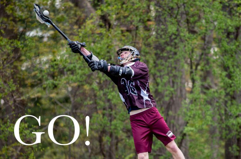 A student catching a lacrosse ball.