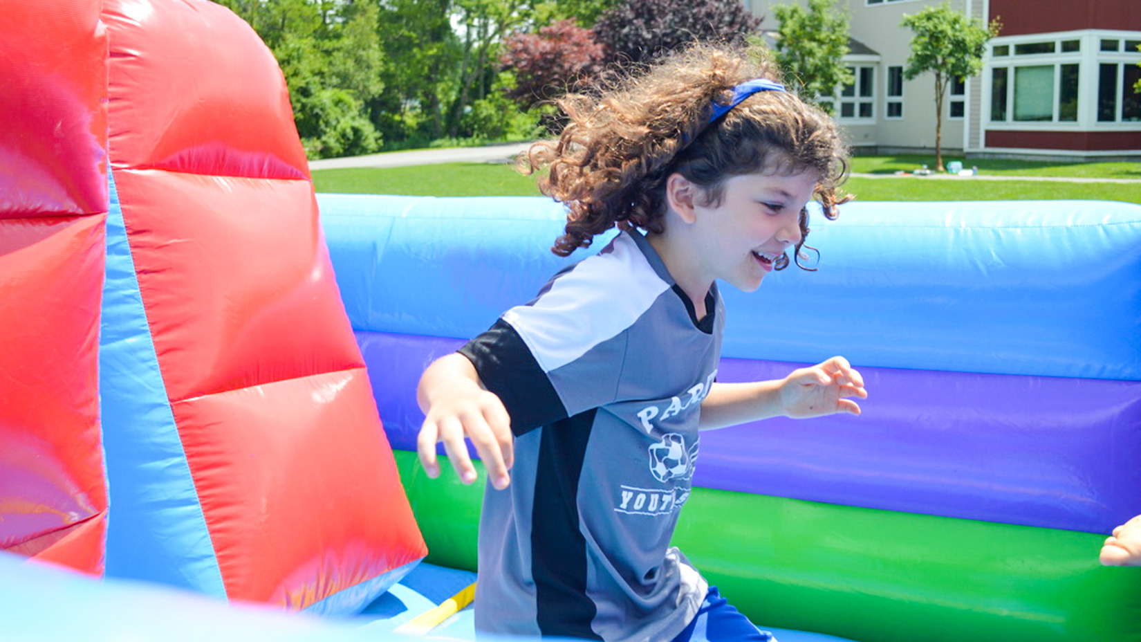 A camper having fun on the bouncy castle.