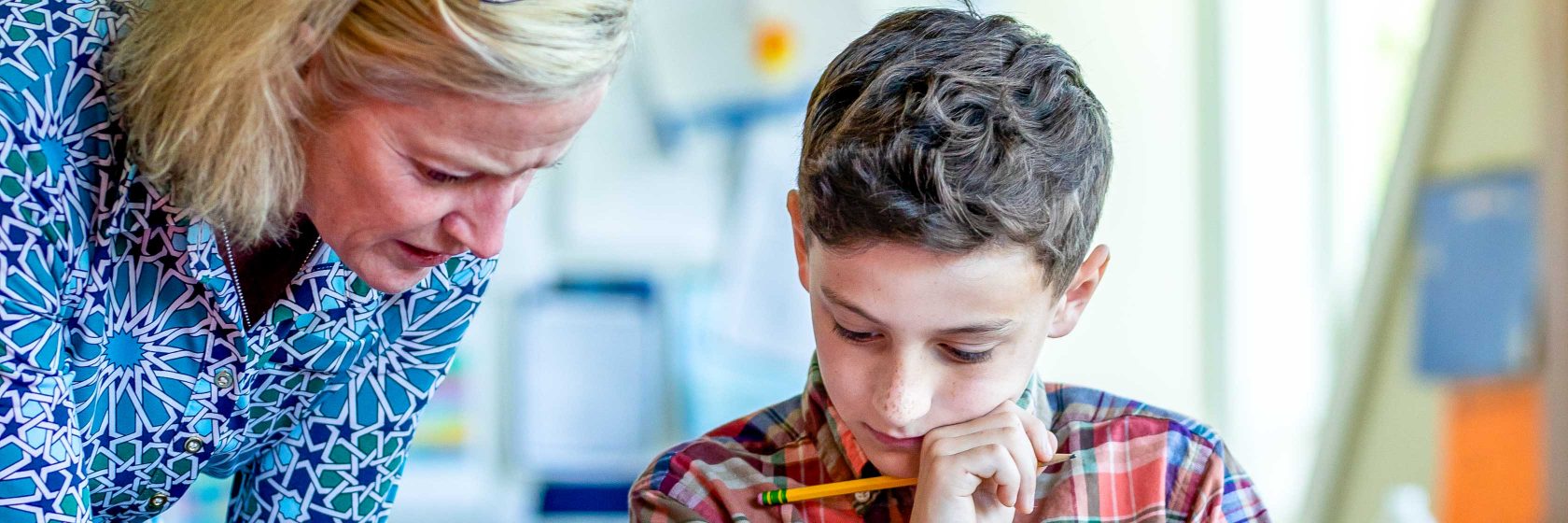 A student getting help with a piece of schoolwork.