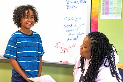 A student presenting in front of the class.