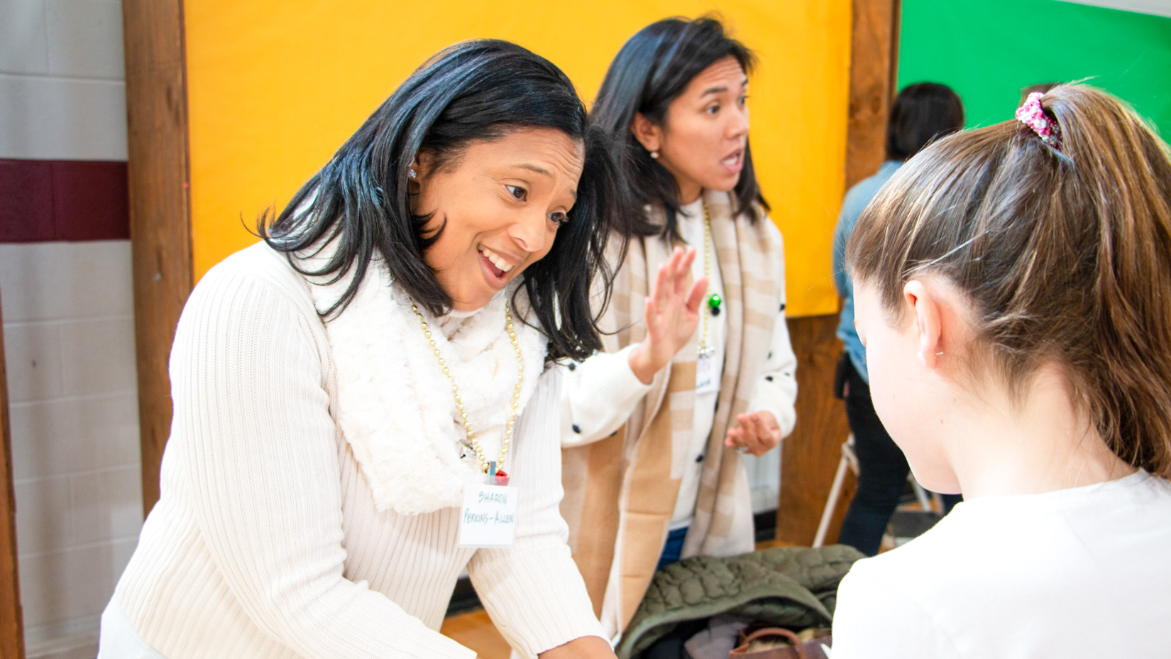 A parent volunteer at an event with a student.