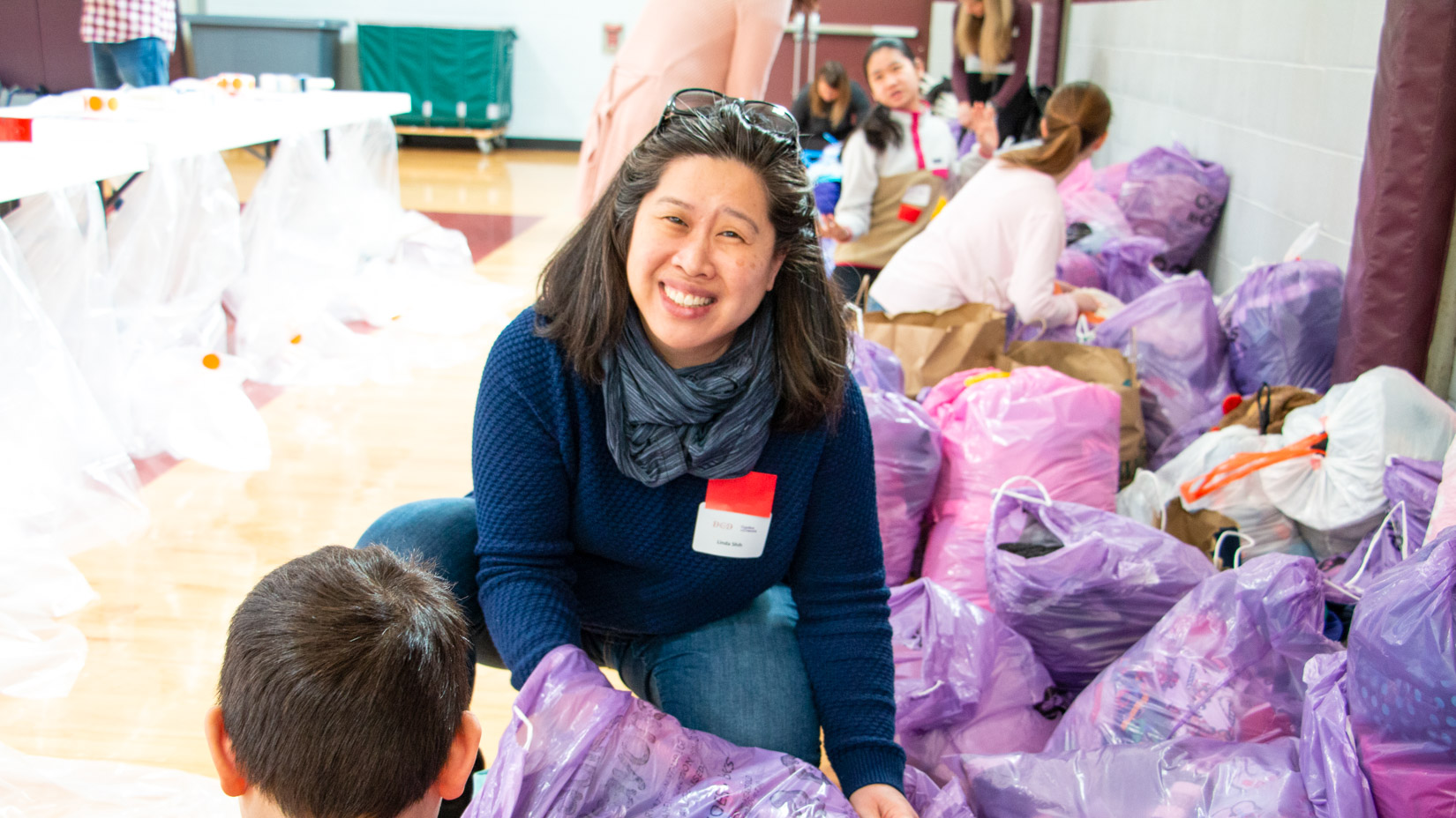 A parent working with donated items at an event.