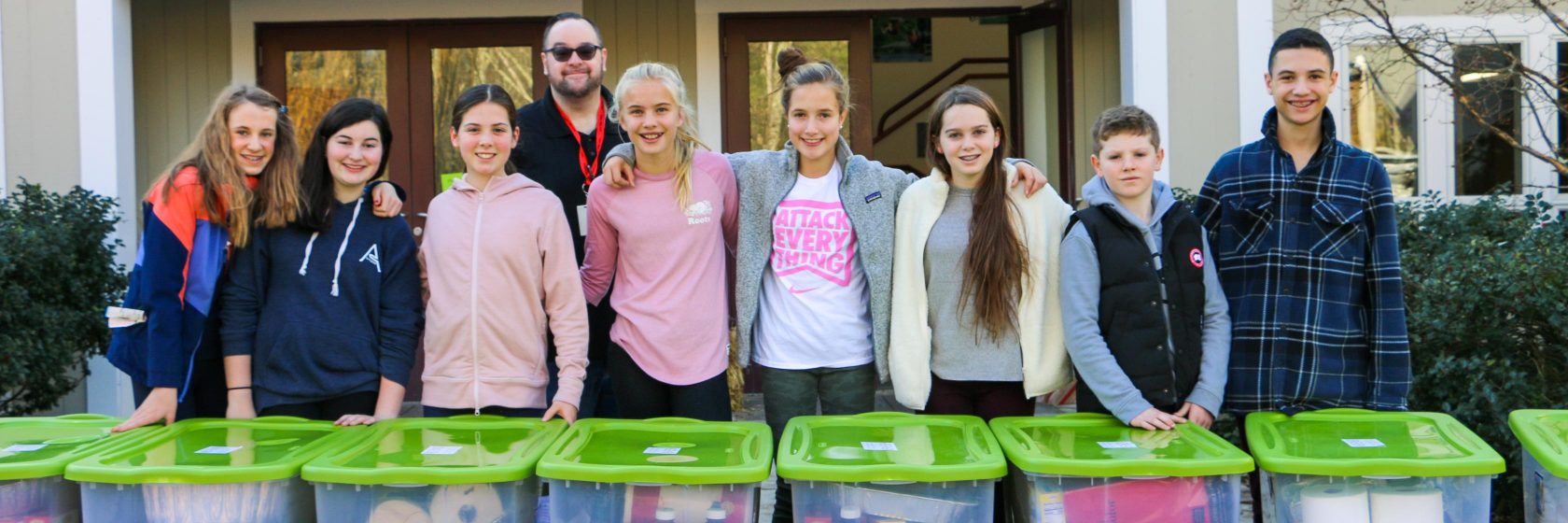 Students posing for a group photo while doing service work.