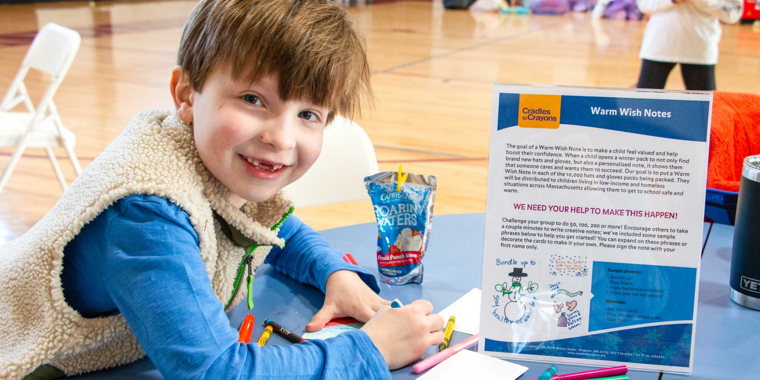 A student smiling while working on a note.