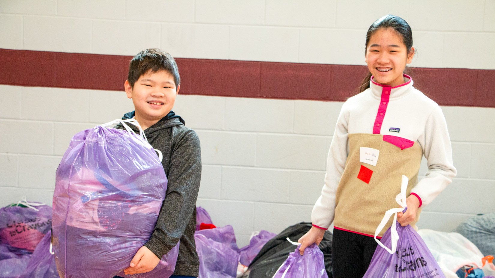 Students with clothes donation bags.