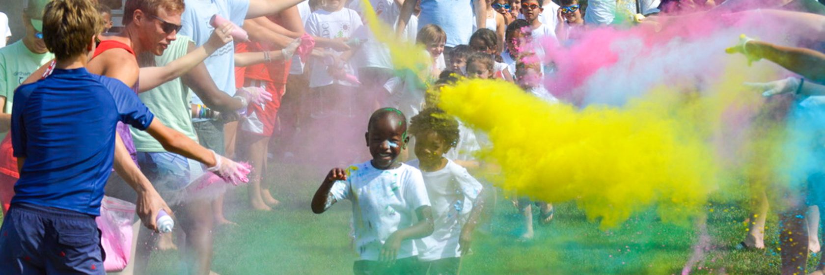 Campers running through colorful powder during camp.