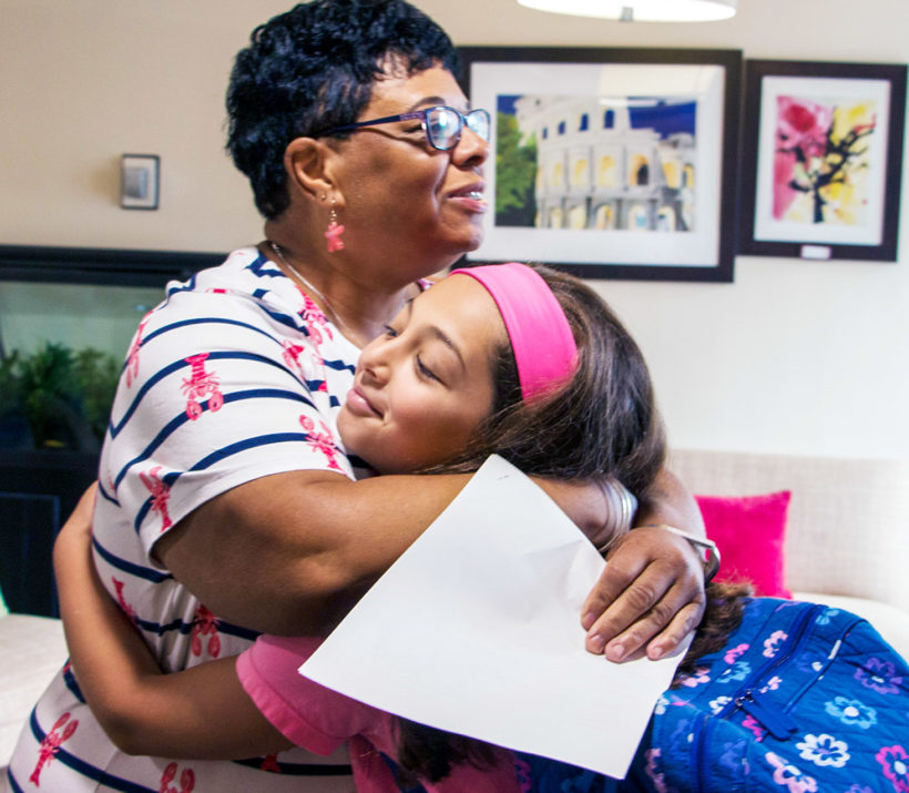 Lynn Mayard hugging a student