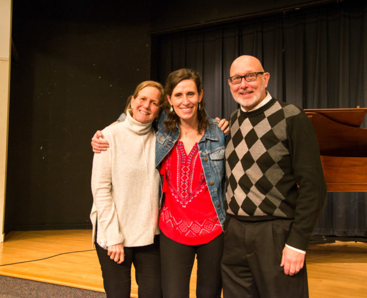 Alumni smiling at the camera at an event