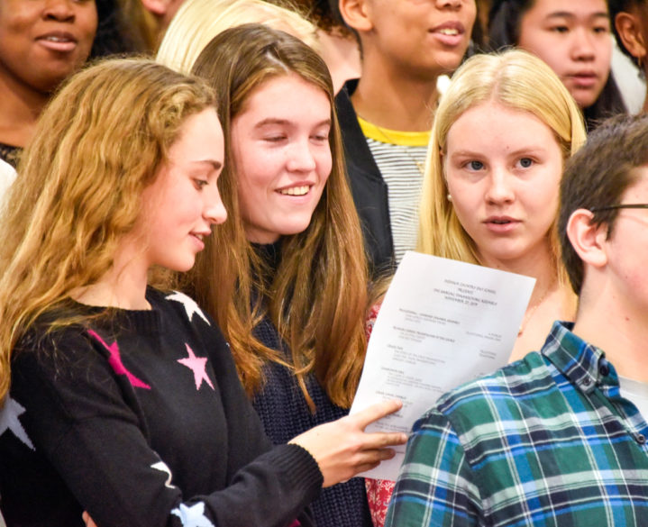 Alumni singing in a ceremony