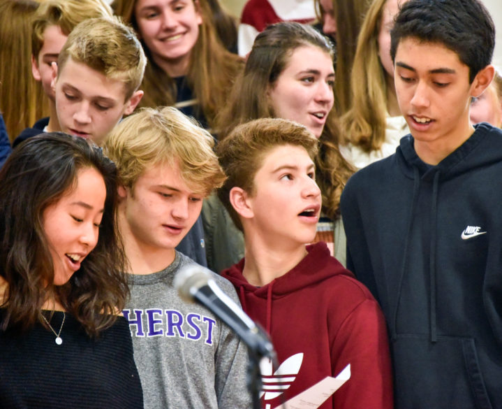 Alumni singing in a ceremony