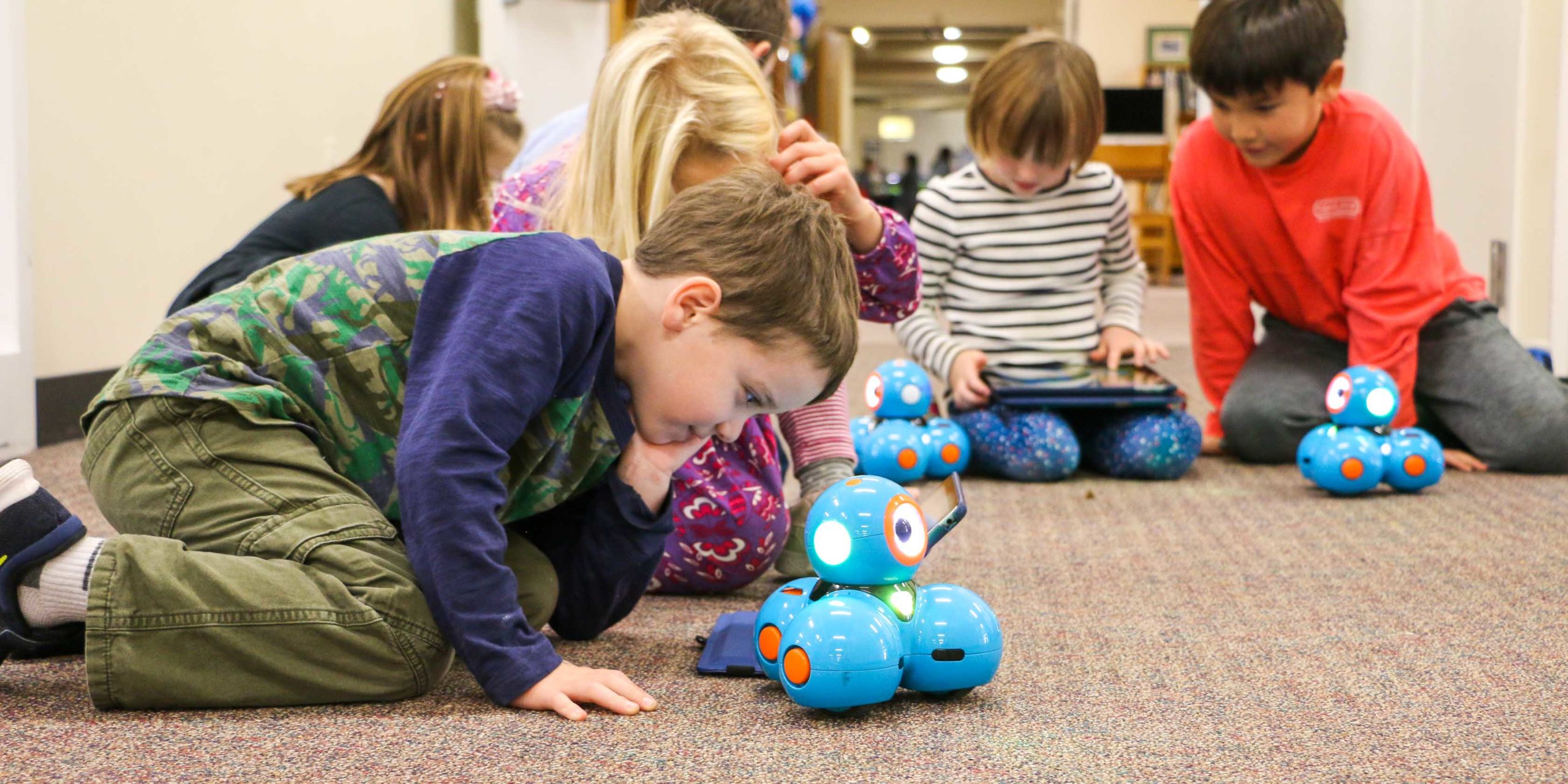 a student playing with a robotic toy