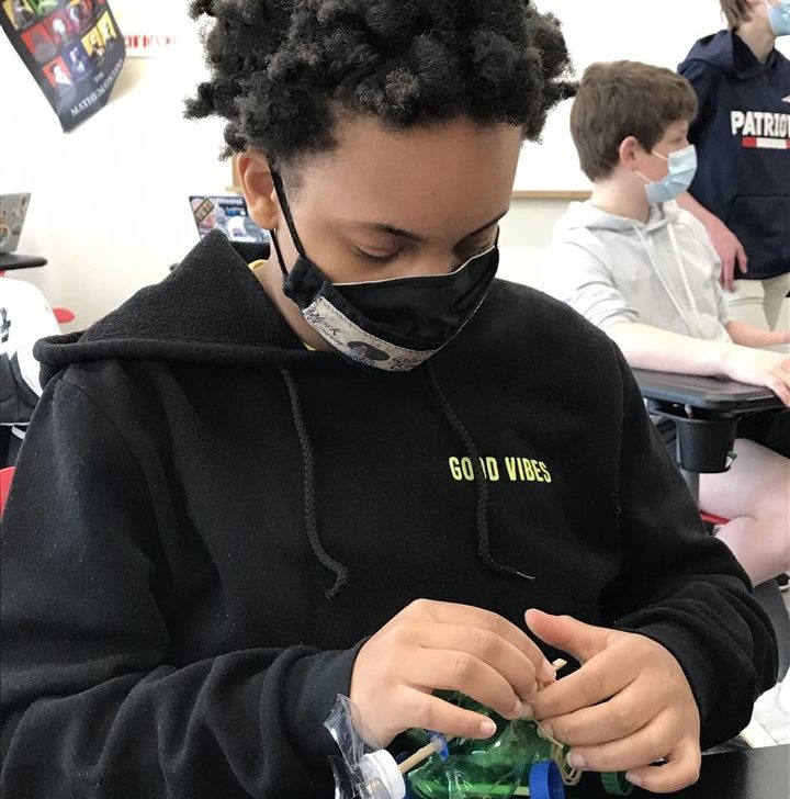 Boy constructing self-propelled vehicle