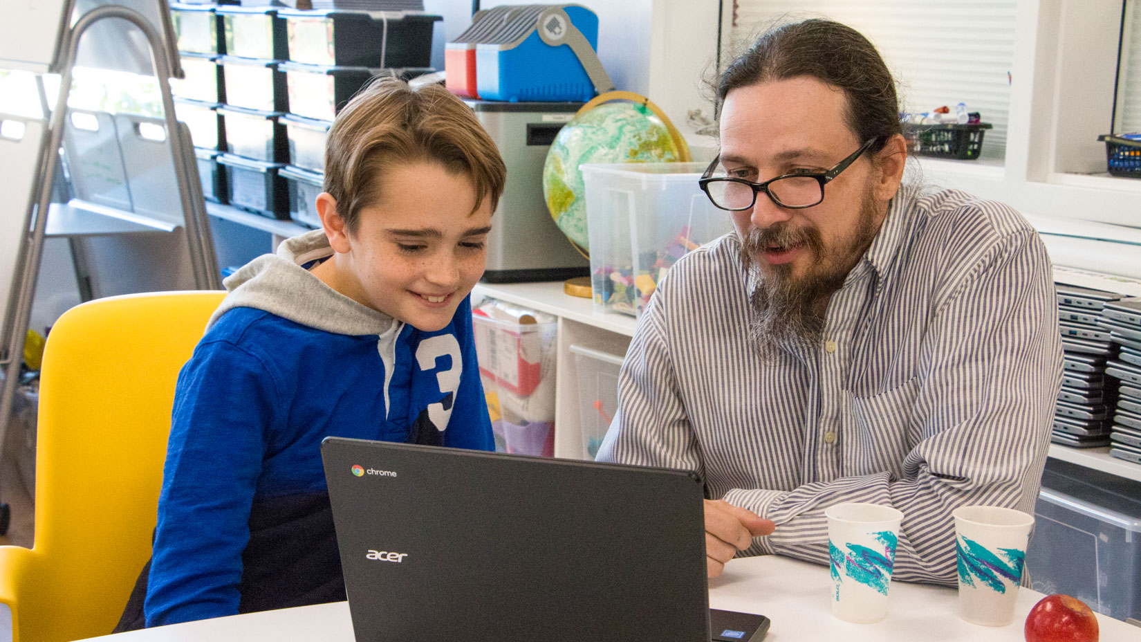 A teacher assisting a student