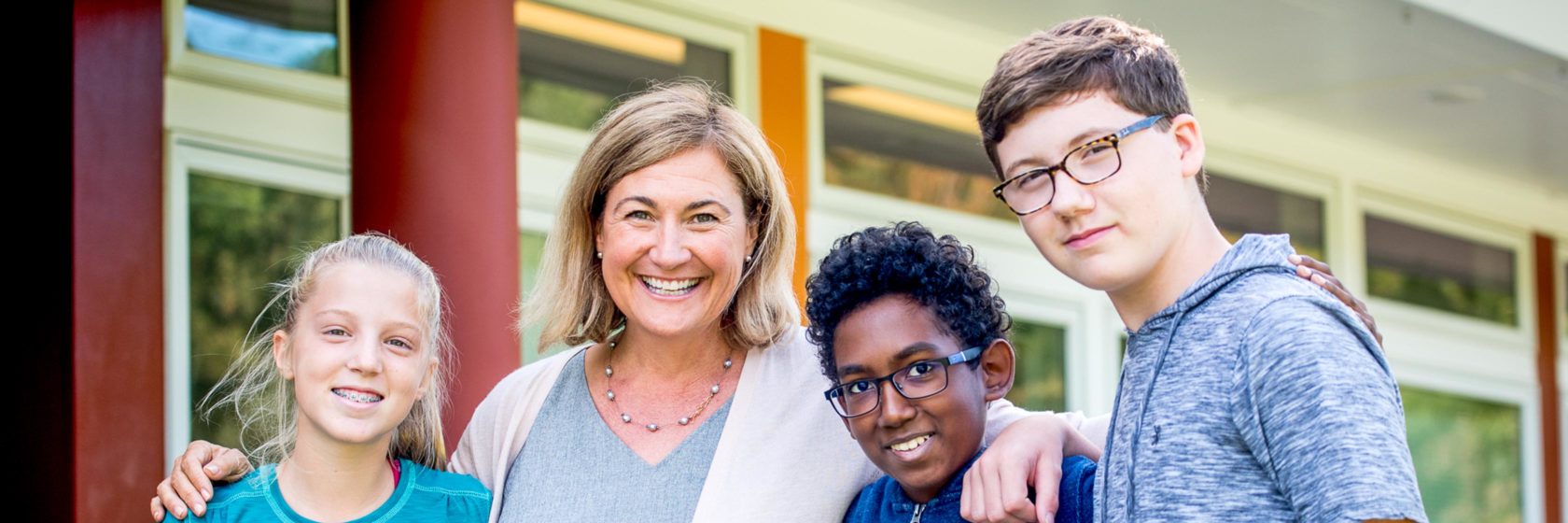 The head of school posing with students