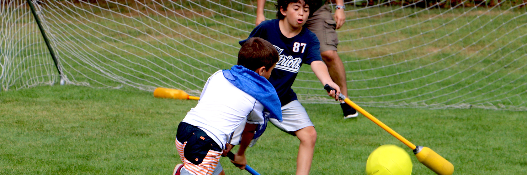 boys playing outside ball hockey
