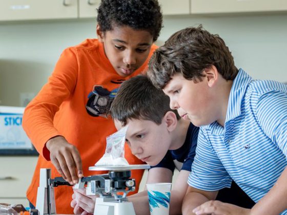 Students looking through a microscope during class.