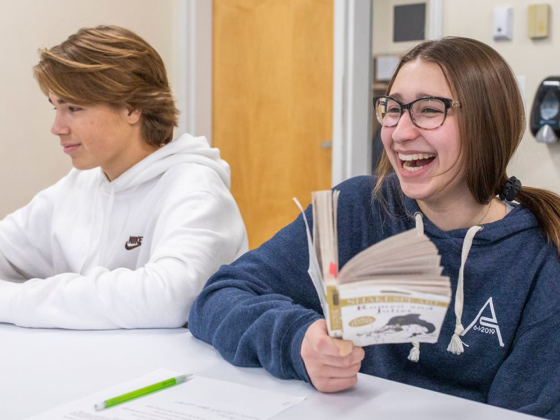 A student laughing and smiling during class.