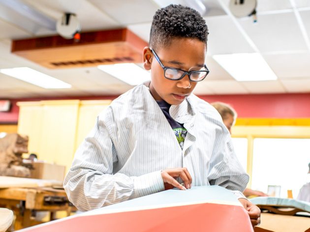 A student working on a wood project.