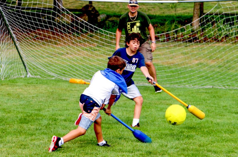 Campers playing a game on a field.