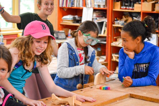 A group of campers working on crafts.