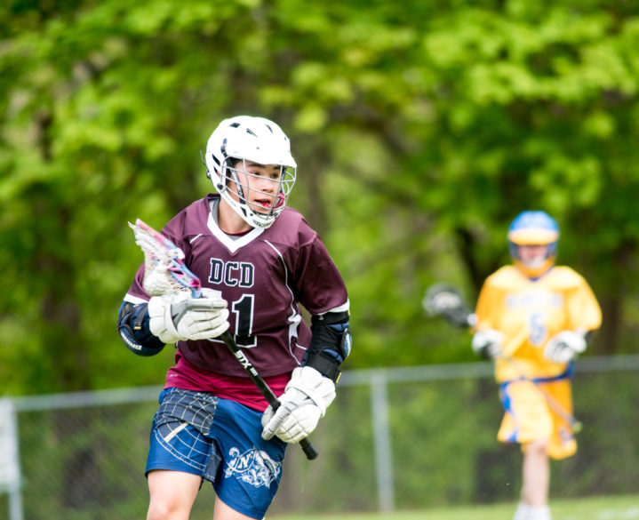 A student playing lacrosse