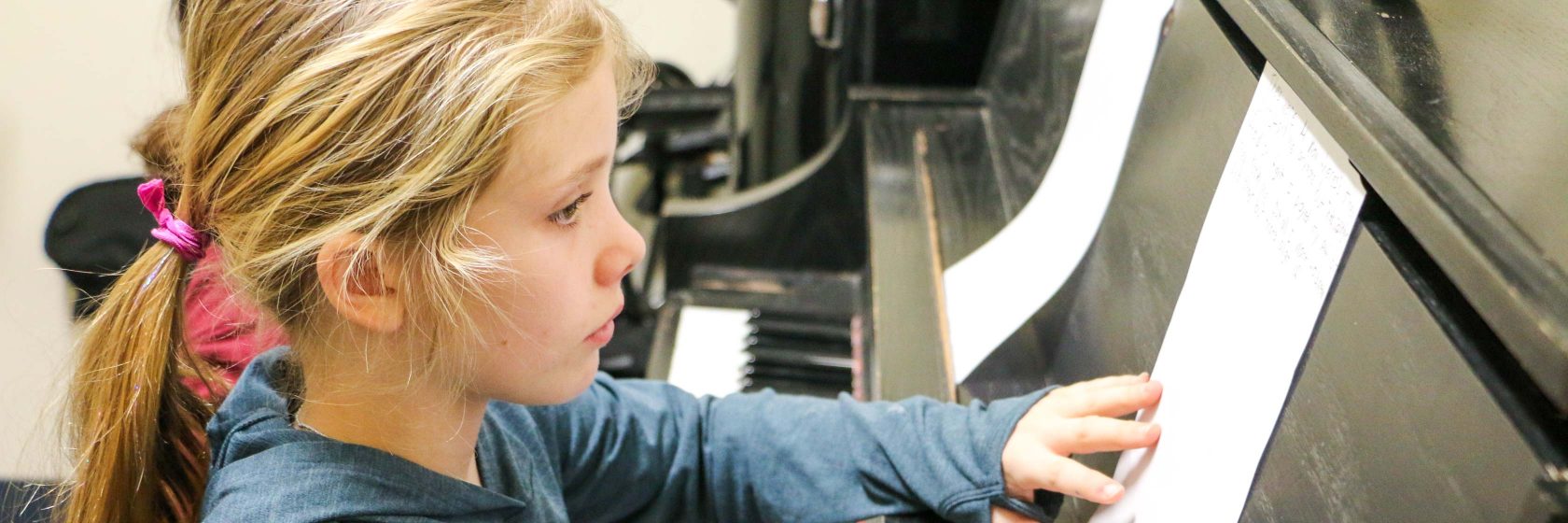 A student working on learning the piano.