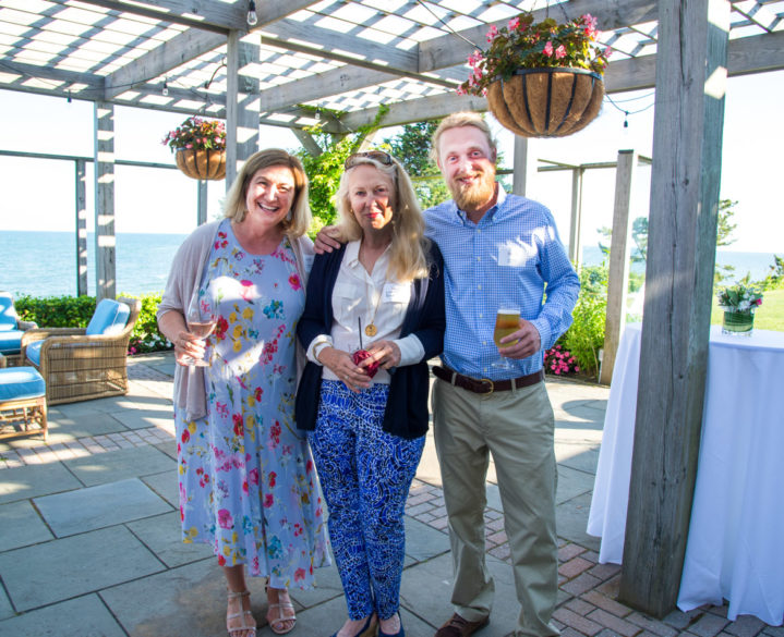 Alumni smiling at the camera at an event