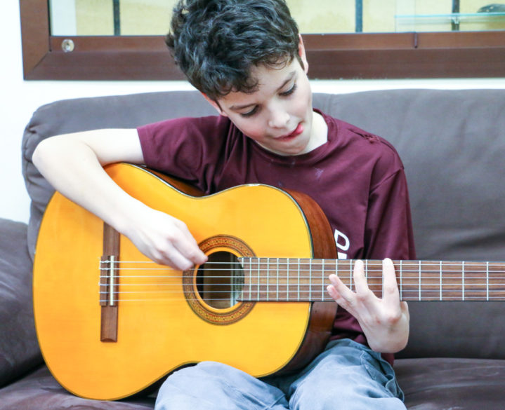 A student playing the guitar