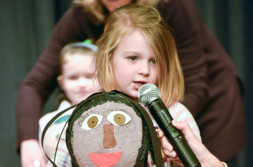 A pre-k student presenting her project.