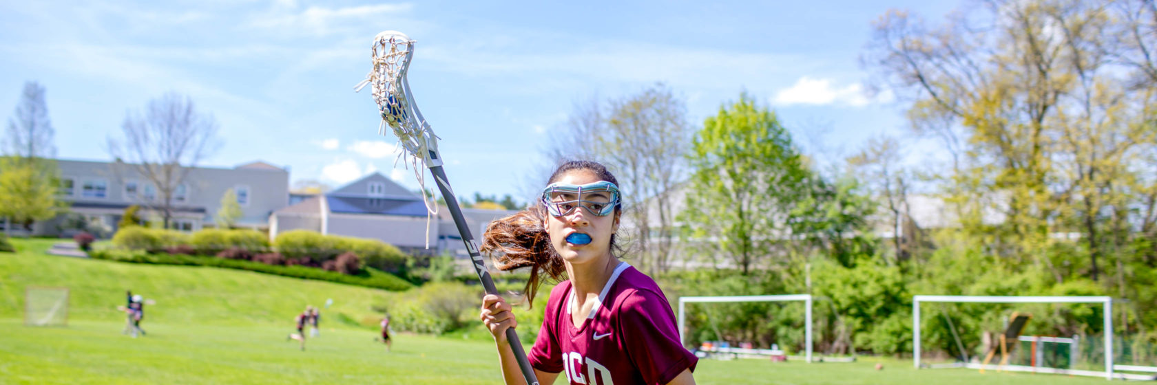 A student playing lacrosse