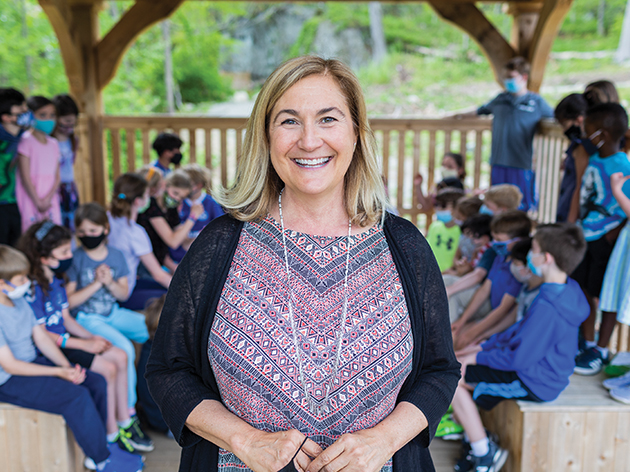 Woman with children in background in outdoor classroom