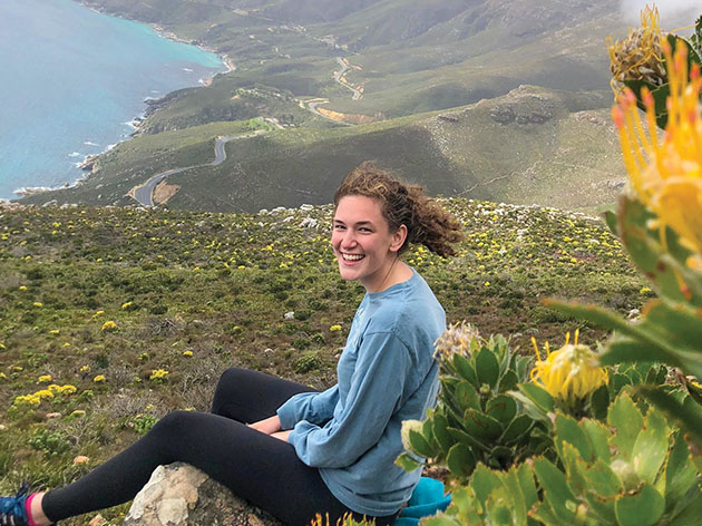 Young woman sitting in the hills of South Africa