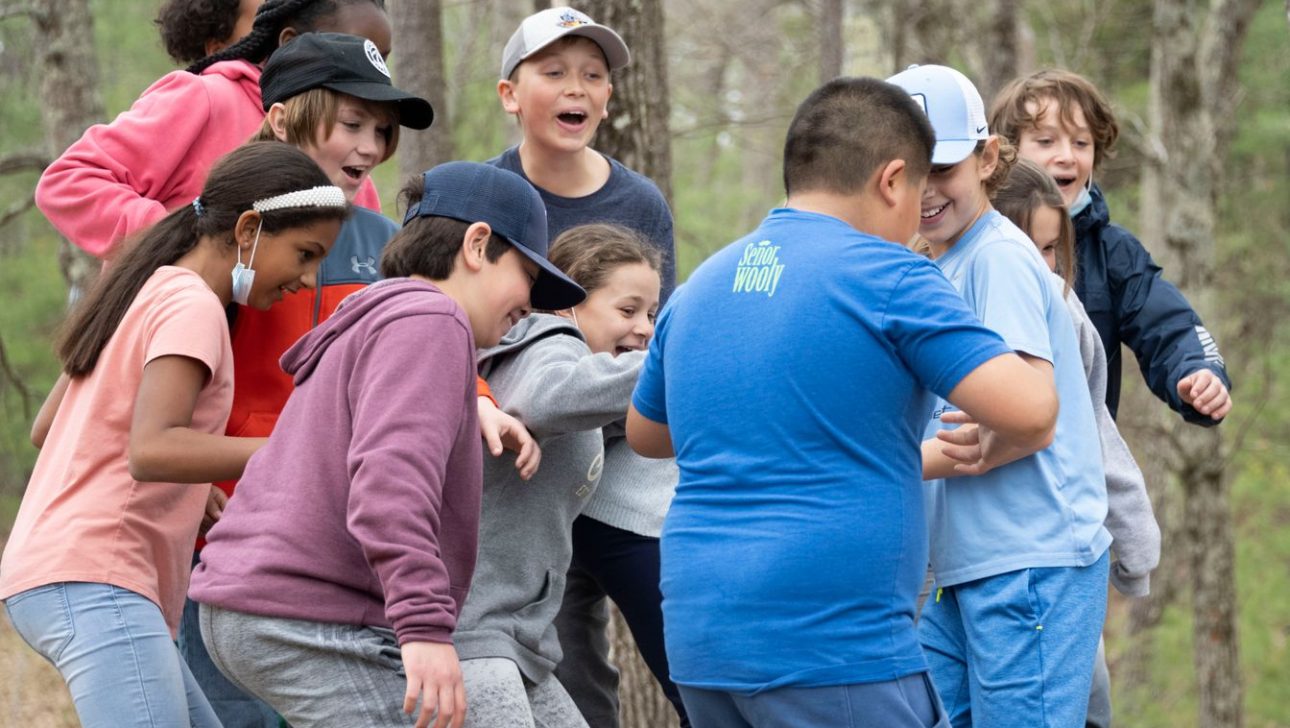 Children balancing on a platform in an outdoor challenge