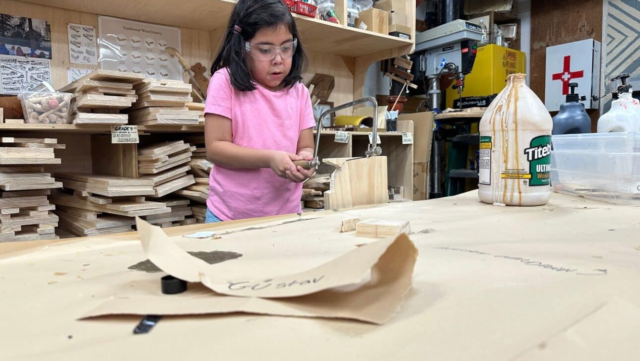Young Student in Woodshop using a coping saw
