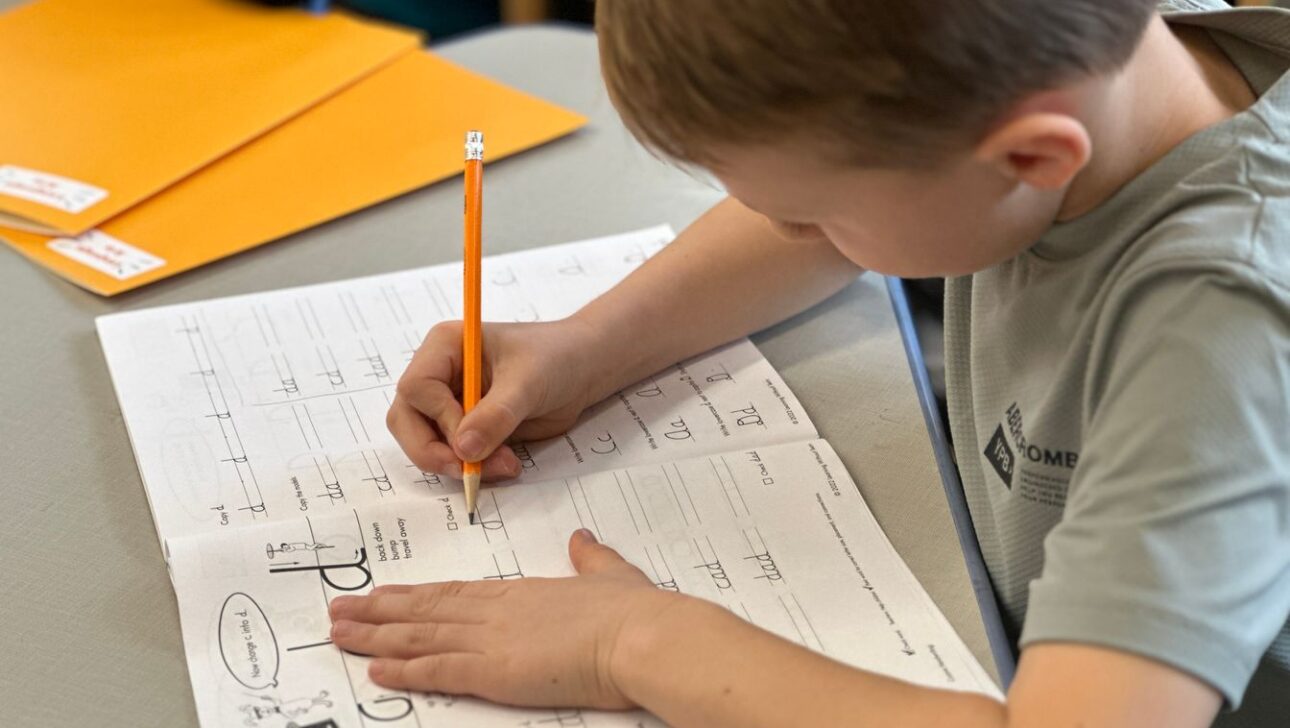 Boy practicing cursive writing skills
