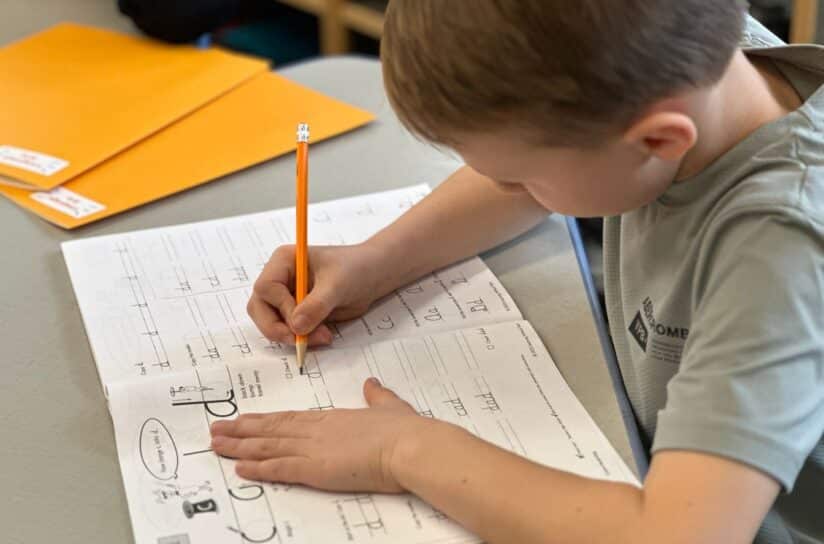 Boy practicing cursive writing skills